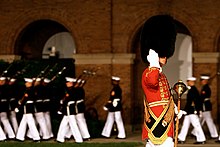 Gunnery Sergeant Duane King of the United States Marine Band salutes during the Friday Evening Parade in June 2018. USMC-120608-M-RT059-031.jpg