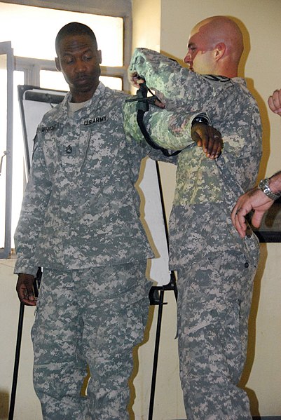 File:US Army 52953 CAMP TAJI, Iraq- Naples, Fla. Native, Sgt. John Juhnke (right), a combat medic, applies a tourniquet to Sgt. 1st Class Ward Wright, during medical training, Oct. 10. The medical training is one of man.jpg