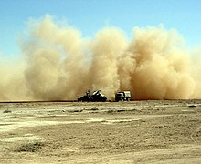 An AH-64A Apache from the 2nd Squadron, 6th Cavalry Regiment, leaves an enormous cloud of dust after landing at a desert airstrip in central Iraq. US Army AH64 dust 14797 41493935.jpg