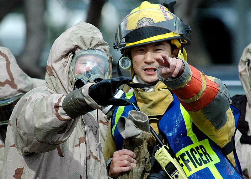 File:US Navy 070201-N-3019M-001 Lt. Scott Margraf, assigned to Naval Branch Health Clinic Sasebo's emergency response team (ERT), discusses tactics with a member of the Federal Fire Department during a mass casualty drill as p.jpg