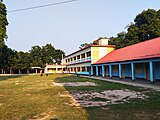 The administrative building of the school and a tin shed building on the right side