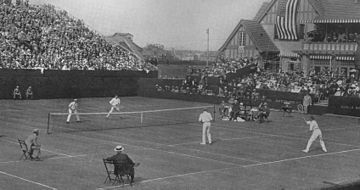1914 International Lawn Tennis Challenge (Davis Cup) finals match between Australasia and the United States played at the West Side Tennis Club in New York on 13-15 August. Players shown on the near side are Norman Brookes (left) and Anthony Wilding (right) for Australasia and on the far side Thomas Bundy (left) and Maurice McLoughlin (right) for the United States. 1914 International Lawn Tennis Challenge.jpg