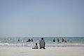 A man sits by the sea on Lido beach with his son in Mogadishu, Somalia, on December 21. (11511102813).jpg