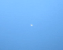 Two bright white dots almost touching on a blue background.