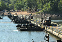 Army Convoy crosses bridge during training exercise.jpg