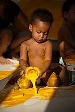 Baby playing with yellow paint. Work by Dutch artist Peter Klashorst entitled "Experimental".jpg