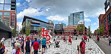 Cardinal fans at Ballpark Village after a game in 2021 Ballpark Village Pano 2021.jpg