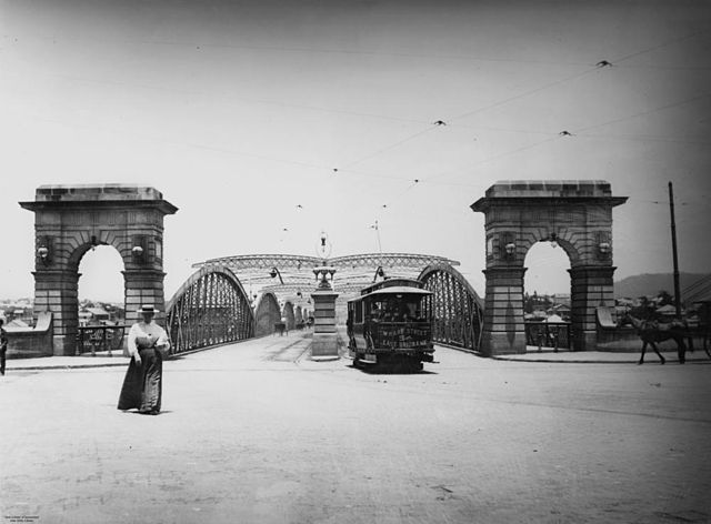 Early electric tram at the northern end of the second permanent Victoria Bridge c. 1906