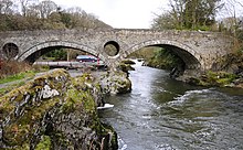 The bridge viewed from downstream north bank (Carmarthenshire right, Ceredigion left) Cenarth Bridge - geograph.org.uk - 1122380.jpg