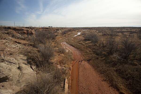 The Colorado River 5 mi (8 km) from its source along the Caprock Escarpment, the border of Dawson and Borden County.