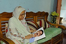 A mother with a photo of her son who became a victim of forced disappearance in 2013 (image by VOA) Forced disappearance-bangladesh-1.jpg