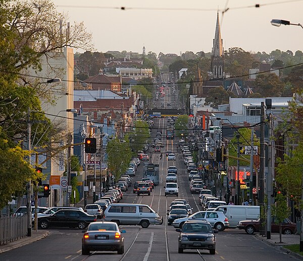 Glenferrie Road facing south, looking down the hill from Kew. Beyond the traffic light is Hawthorn, and the foreground is in Kew, as Barkers Road form