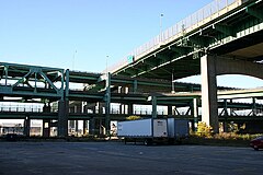 Massachusetts Route 79 viaduct and Braga Bridge in Fall River. The Quequechan River flows beneath the parking lot. The viaduct was demolished in 2014 and replaced with a surface boulevard. Highway 79.jpg