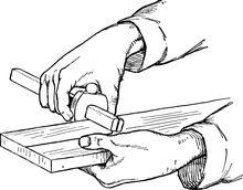 Marking out wood with a marking gauge Illustration showing how to use a marking gauge.png