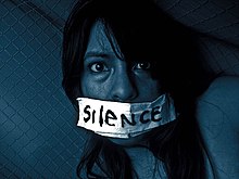 A distressed woman with her mouth taped shut. Innocent's Silence.jpg