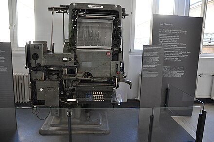 An Intertype Fotosetter, one of the most popular "first-generation" mass-market phototypesetting machines. The system is heavily based on hot metal typesetting technology, with the metal casting machinery replaced with photographic film, a light system and glass pictures of characters.