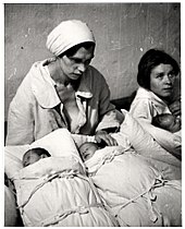 Polish mothers with their newborn infants in a makeshift maternity ward inside a hospital basement during the Bombing of Warsaw by the German Luftwaffe Julien Bryan - Look - 47218.jpg