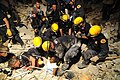 A Haitian woman is pulled from earthquake debris