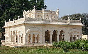 A cream-coloured building with ornate arches