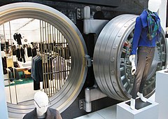 The bank vault door and vault opening later became the backdrop for a clothing display. Manufacturers Trust Company Building bank vault door.jpg