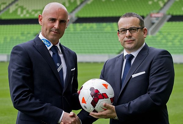 Kevin Muscat alongside Melbourne Victory chairman Anthony Di Pietro at the Melbourne Rectangular Stadium in October 2013.