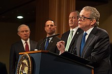 DeWine delivers remarks at the Department of Justice in 2018. Ohio Attorney General Mike DeWine delivers remarks.jpg