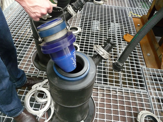 Figure 8. A Jameson Cell slurry lens being inserted into the top of a downcomer. Photograph of Jameson Cell slurry lens.png