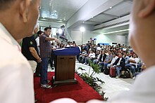 Philippines President Rodrigo Duterte speaking to a group of repatriated overseas Filipino workers from Saudi Arabia in 2016 President Rodrigo Duterte speech with repatriated overseas Filipino workers from Saudi Arabia.jpg