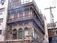 Some buildings in the old city feature carved wooden balconies. Qissa Khwani Bazaar, Peshawar, Pakistan - panoramio - franek2.jpg
