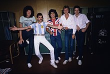 Diego Maradona (center, with members of the rock band Queen) was a descendant of Galician, Italian and Croatian immigrants, and of Guarani natives. Queen maradona.jpg