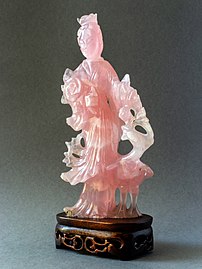 Rose quartz statuette of a woman with flowers and a bird