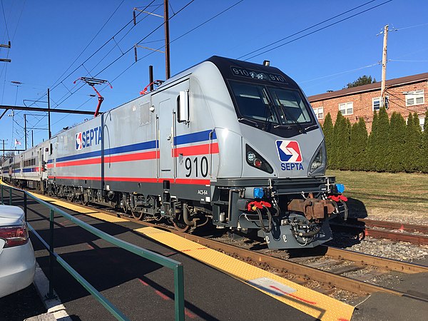 A SEPTA ACS-64 910 leads a train out of Hatboro station