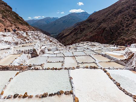Salineras (salt evaporation ponds) in Maras, Peru. The salt is obtained in Maras since the Inca Empire times and the site is currently composed of around 3.000 ponds of 5 square metres (54 sq ft) each. As the location is surrounded by salty mountains, subterrean water deposits the salty wather in the ponds and the water evaporates due to the exposure to the sun. After aprox. 1 month the level of salt reaches 10 centimetres (3.9 in) and is removed in sacks.