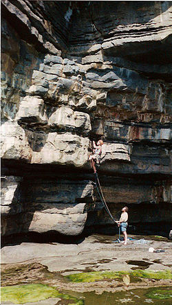 A climber starting The Barb, an E1/5b climb at Muckross Head.