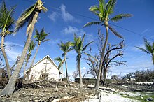 Damaged trees and debris left by Super Typhoon Ioke in 2006 at the Memorial Chapel on Wake Island Wake Island Memorial Chapel damaged by Hurricane-Typhoon Ioke 2006.jpg