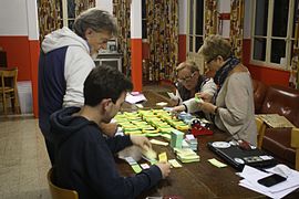 Wikimania 2016 volunteers sorting food stamps 04.jpg