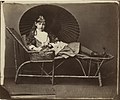 Xie Kitchin partly in the Penelope Boothby dress, on a garden chair, with a Japanese sunshade, by Lewis Carroll on 1 July 1876.