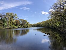 Westons Mill Pond, with East Brunswick on the left and Rutgers University on the right 2024-04-26 15 40 55 View southwest up Weston's Mill Pond from the spillway near the northeast end of the Mill Pond Trail within Frank G. Helyar Woods at the Rutgers Gardens in New Brunswick, Middlesex County, New Jersey.jpg