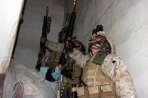 AR RAMADI, Iraq (December 8, 2005) - Marines with 4th Platoon, Company I, 3rd Battalion, 7th Marine Regiment, search a store for hidden illegal weapons during Operation Skinner Dec. 8. Photo by Cpl. Shane Suzuki AR RAMADI, Iraq (December 8, 2005) - Marines with 4th Platoon, Company I, 3rd Battalion, 7th Marine Regiment, search a store for hidden illegal weapons during Operation Skinner Dec. 8. Photo by Cpl. Shane Suzuki.jpg