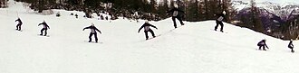 Synthetic photograph with several appearances of snowboarder gliding over a snow-covered valley