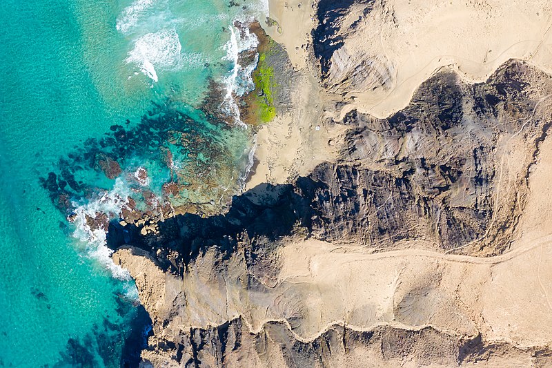 File:Aerial view of volcanic mountains at the beach Playa del Viejo Reyes on Fuerteventura, Canary Islands (51122805502).jpg