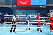 Deutsch: Boxen bei den Olympischen Jugendspielen 2018 Tag 12, 18. Oktober 2018 - Finale Fliegengewicht Mädchen – Martina La Piana (Italien, blau) schlägt Adijat Gbadamosi (Nigeria, rot) 5-0; Ringrichter ist James Beckles (Trinidad und Tobago). English: Boxing at the 2018 Summer Youth Olympics on 18 October 2018 – Girl's flyweight Gold Medal Bout - Martina La Piana (Italy, blue) beats Adijat Gbadamosi (Nigeria, red) 5-0; Referee is James Beckles (Trinidad and Tobago). Español: Boxeo en los Juegos Olímpicos Juveniles de Verano de 2018 en 18 de octubre de 2018 - Combate a medalla de oro de peso mosca para mujeres: Martina La Piana (Italia, azul) le gana a Adijat Gbadamosi (Nigeria, roja) 5-0; El árbitro es James Beckles (Trinidad y Tobago).