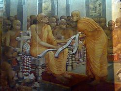 Buddhaghosa with three copies of Visuddhimagga