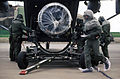 Ground crew personnel unload an aircraft engine from the rear hatch of a C-23A Sherpa.