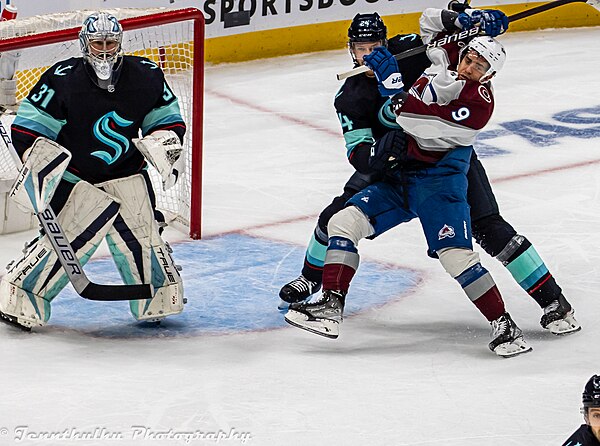 Rodrigues as a member of the Colorado Avalanche battles for position against Jamie Oleksiak (left) in 2023.