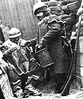 Distribution of pinard (ration wine) in a French trench in winter, considered important for morale Distribution de pinard.jpg