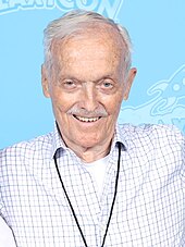 The departure of Don Bluth, seen here in 2023, as well as several other animators caused the film's original release date of Christmas 1980 to be delayed by over six months. Don Bluth Photo Op GalaxyCon Raleigh 2023.jpg