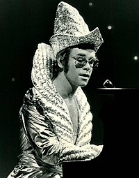 Elton John amassed the second-most number-one hits on the Hot 100 chart during the 1970s (6 songs). Elton john cher show 1975.JPG