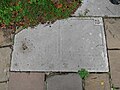 Gravestone used as paving outside the medieval Church of Saint Peter and Saint Paul in Milton-next-Gravesend.