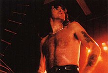 Bon Scott, the band's former vocalist, in December 1979. Grenoble79 01.jpg